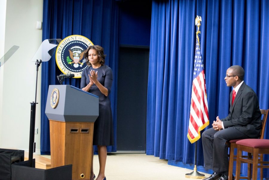 First lady Michelle Obama praises Troy Simon, who couldn’t read at age 14 and is now a college student, at a White House conference for education leaders, photo by Gavin Stern